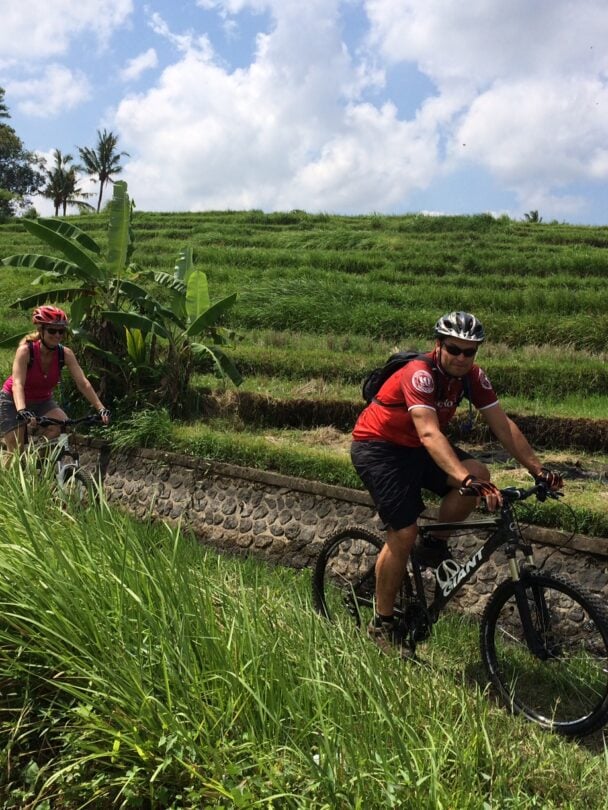 Bikers cycling through a field in Bali